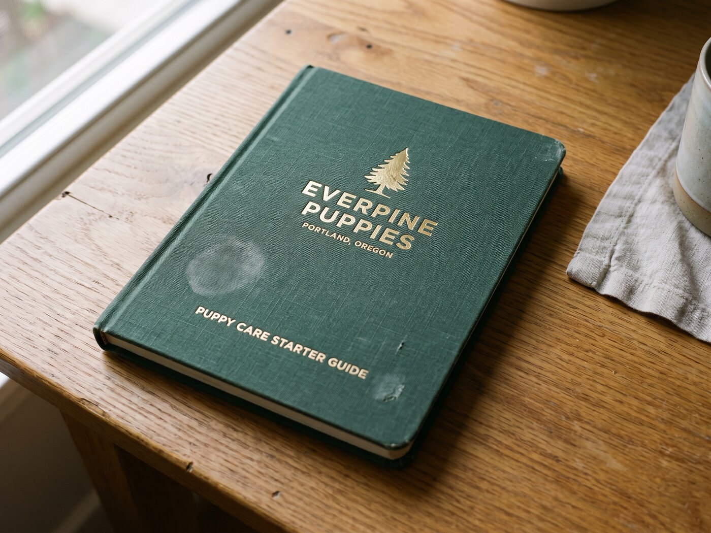 The Everpine Puppies Puppy Care Starter Guide, shown closed and open
