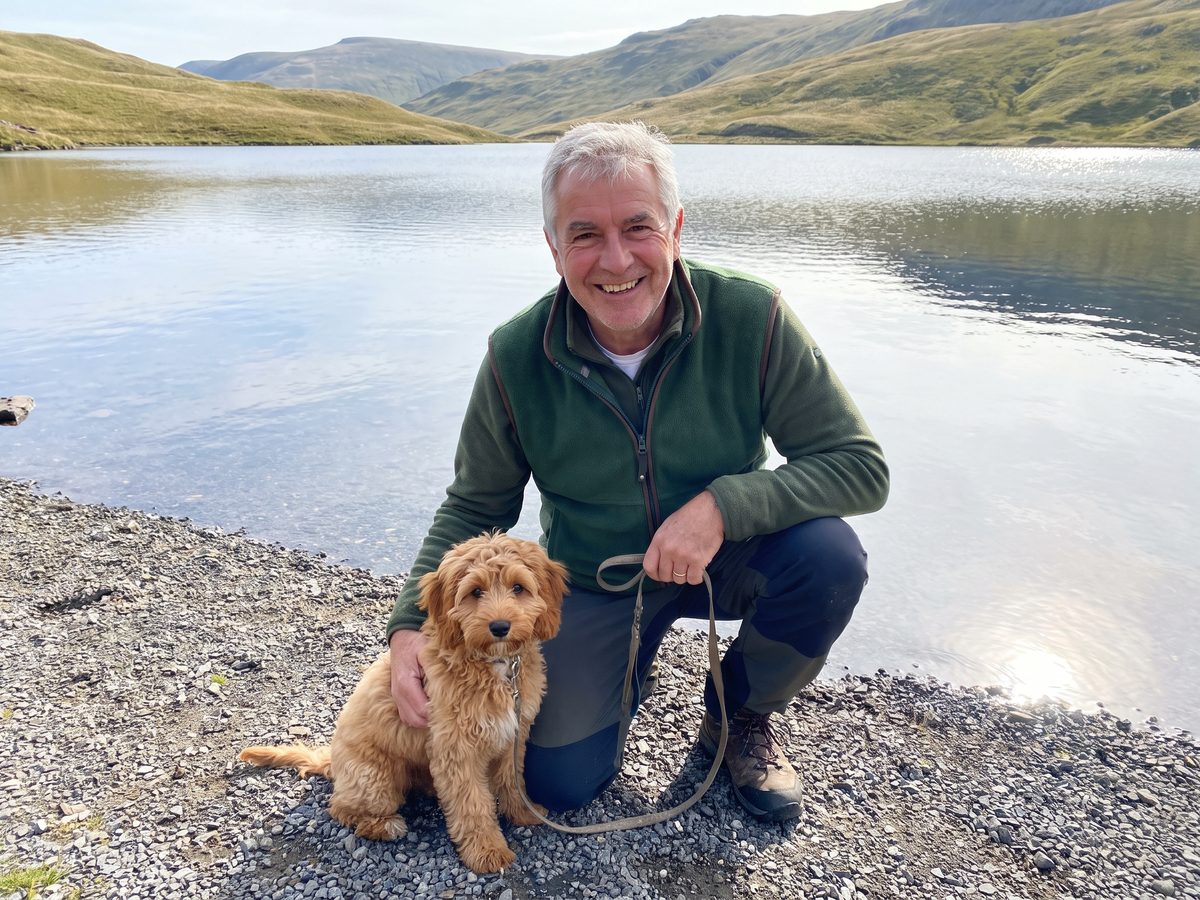 Frank with his Cavapoo puppy Murphy by a lake